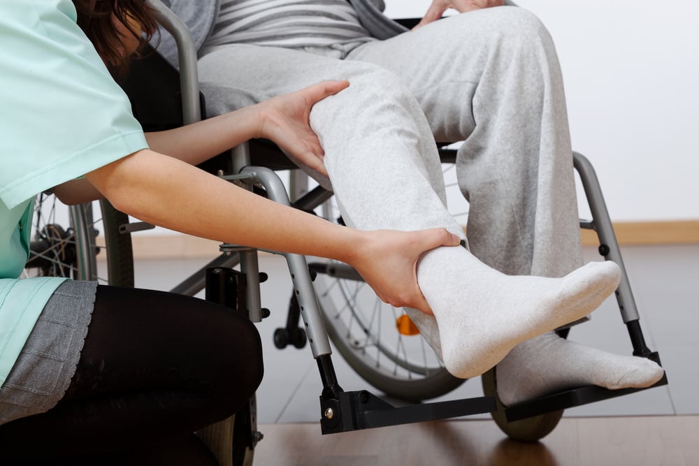 Young physiotherapist exercising with elder disabled person Young physiotherapist exercising with elder disabled person