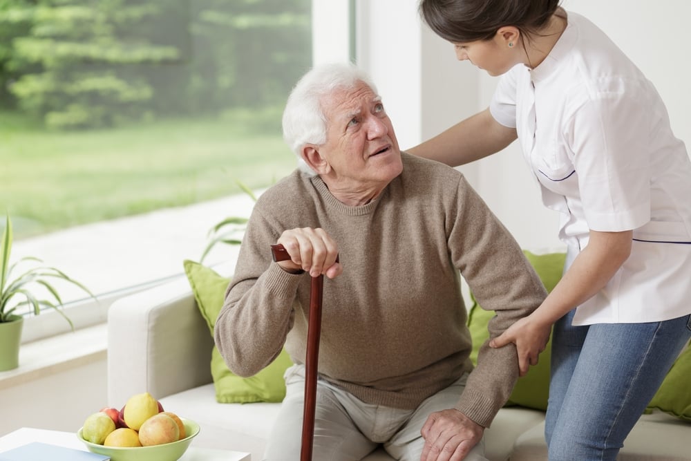 Young woman helping old man to stand up Young woman helping old man to stand up